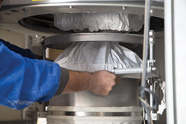 Die Entleerung von Big-Bags in eine pneumatische Förderung steigert die Produktivität bei der Kunststoff-Verbundmaterialhandhabung